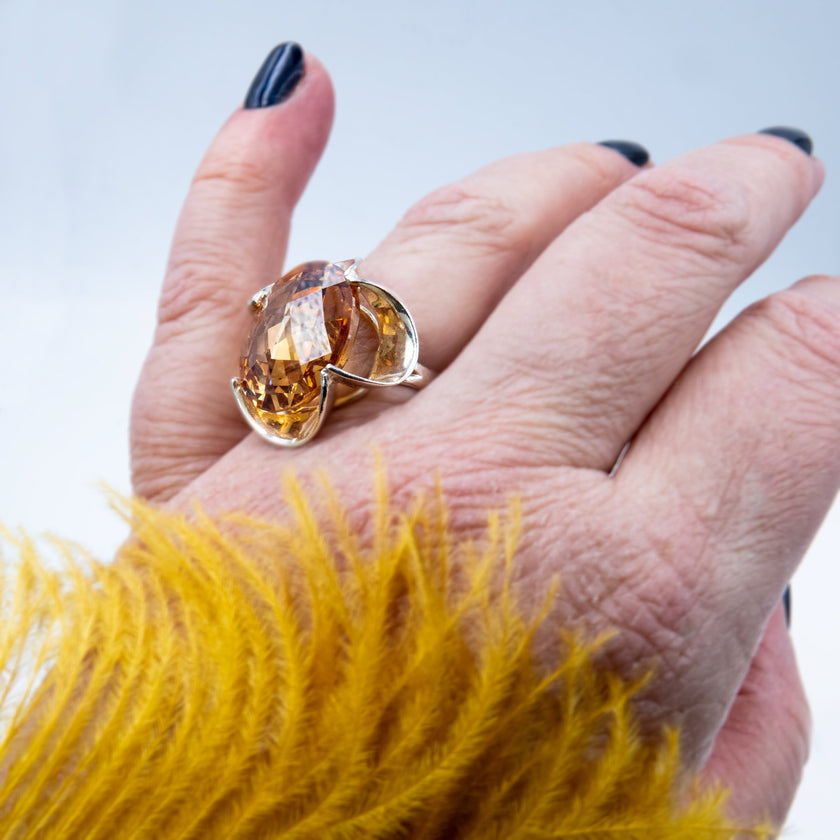 Silver ring with a crystal in the shade of citrine