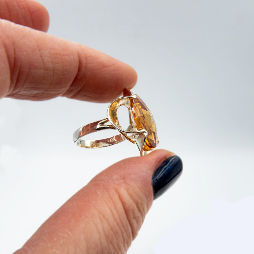 Silver ring with a crystal in the shade of citrine