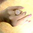 A silver ring with mother of pearl in a delicate pink shade