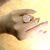 A silver ring with mother of pearl in a delicate pink shade