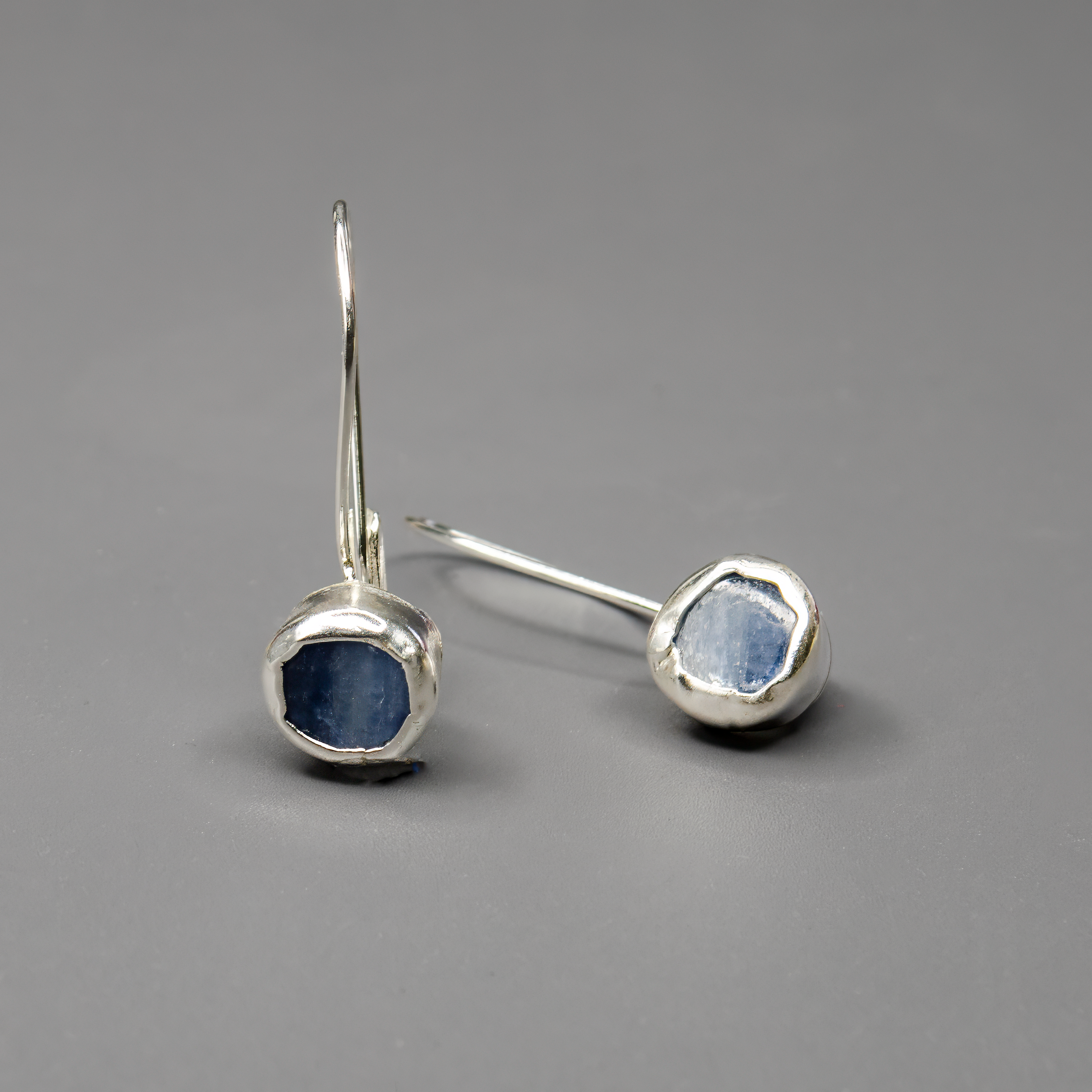 עגילים מכסף סטרלינג בעיצוב עדין וייחודי, משובצים באבן קיאנייט כחולה בגוון שמחליף טונים באור. כל זוג עגילים עשוי בעבודת יד באהבה ובדיוק. תכשיט שמשלב אנרגיה רוחנית, צבע מעודן ואלגנטיות שקטה – מתאים לנשים עם טעם אישי מדויק ונגיעה של עומק.

