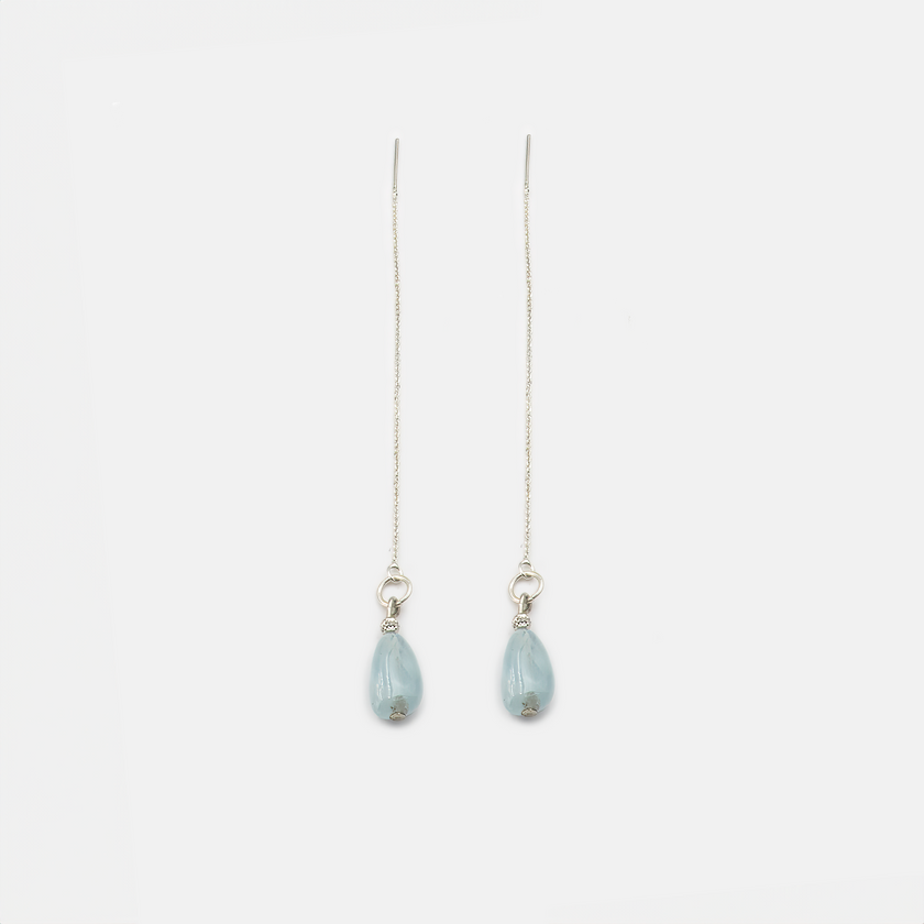 עגילי שרשרת קלאסיים בעיצוב עכשווי, עם תליון אקוומרין טבעי שמשתלב בזהב לבן 14 קראט. התוצאה: תכשיט שמתאים גם למראה ערב מתוחכם וגם ליום-יום עם טאץ’ של זוהר. האקוומרין מקרין רוגע ואיזון, והעיצוב הנקי מביא לידי ביטוי את יופיו של החומר הטבעי. מתנה נהדרת או פינוק אישי – תכשיט שמביא עמו תחושת שלווה פנימית ונוכחות שקטה.