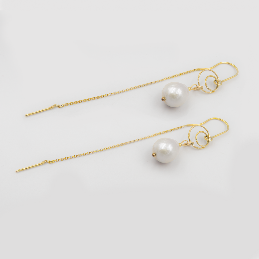 עגילי שרשרת אלגנטיים בעבודת יד עם פנינה לבנה עגולה ועדינה. תכשיט על-זמני עם נוכחות רכה ומרשימה שמתאים לרגעים הכי משמעותיים – מושלם לכלה שמחפשת עגילים קלילים עם ברק קלאסי, או לאמא של הכלה/החתן שמבקשת להיראות במיטבה בטקס מרגש.

