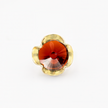 A silver ring combined with a crystal in the shade of garnet