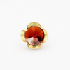 A silver ring combined with a crystal in the shade of garnet