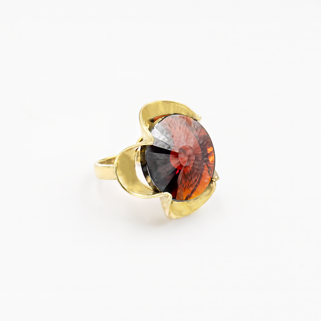 A silver ring combined with a crystal in the shade of garnet