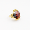 A silver ring combined with a crystal in the shade of garnet