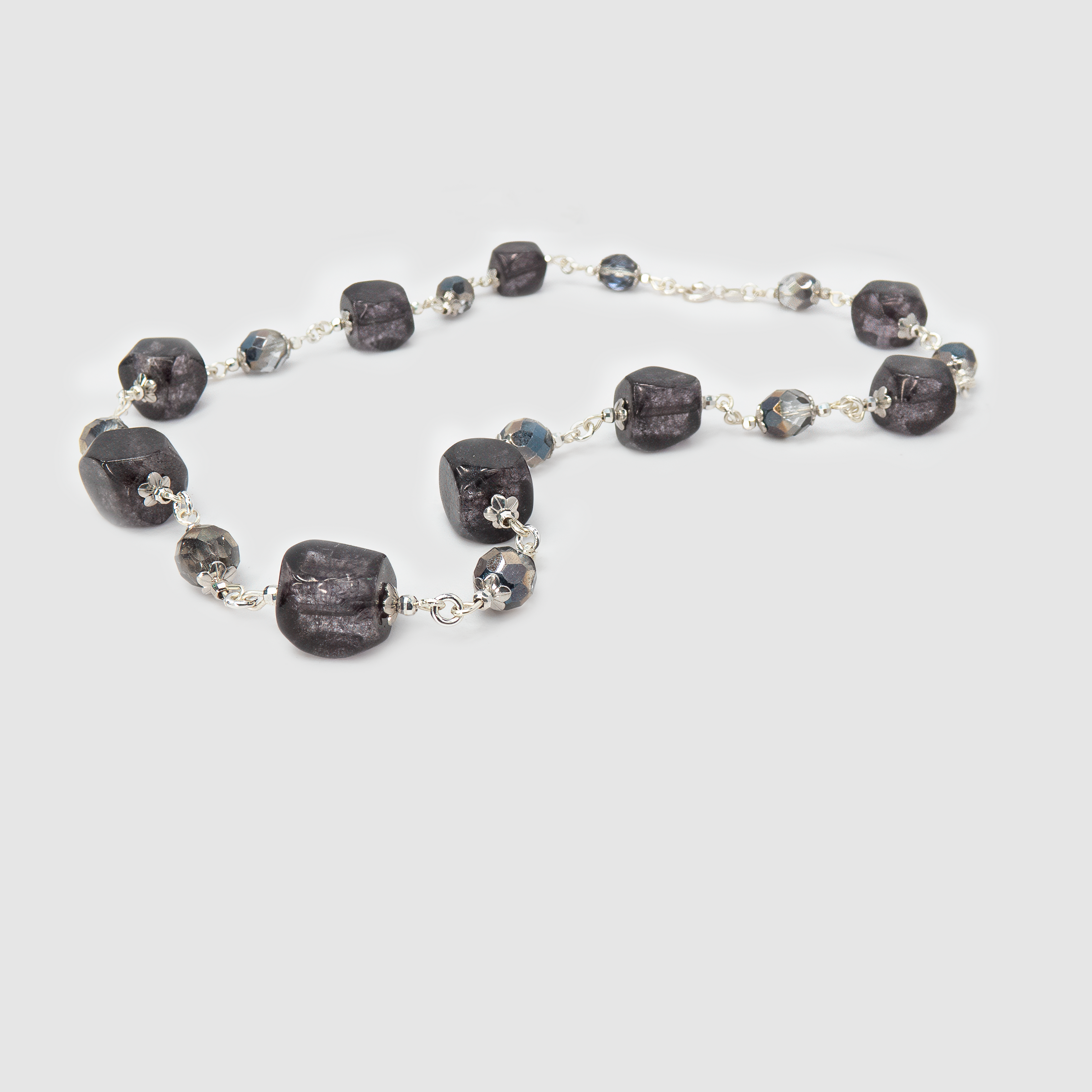 שרשרת אלגנטית בעבודת יד המשובצת אבנים בגווני אפור – מאפור פנינתי רך ועד גוון גרפיט עמוק. האבנים מבריקות באור עדין ומשתלבות בעיצוב הרמוני שמקרין איזון, עומק ותחכום. תכשיט מינימליסטי אך בעל נוכחות מרשימה, שמתאים ללבוש יומיומי מוקפד או כהשלמה מושלמת להופעת ערב מעודנת.

