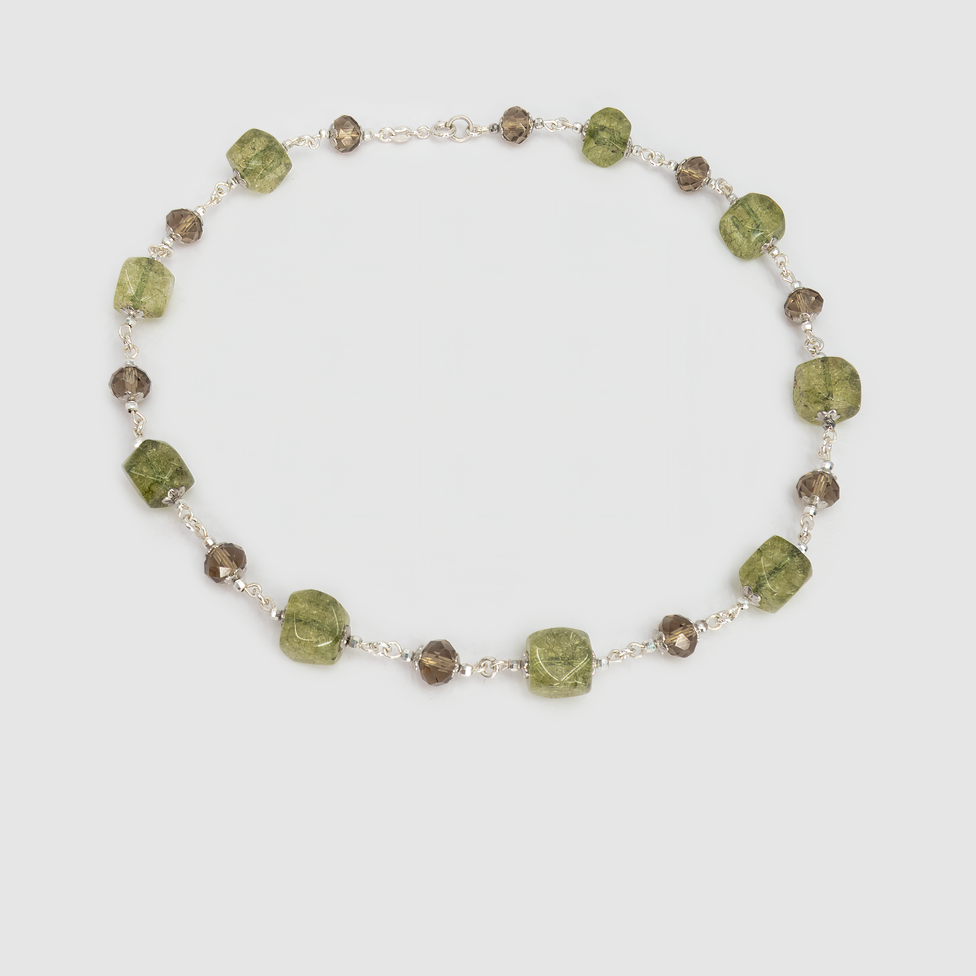 תכשיט בהשראת יערות ירוקים ואדמת טרה קוטה – ענק אבנים בעבודת יד בגווני ירוק-חום עמוקים. אבנים חלקות ואטומות לצד כאלה עם שקיפות עדינה מעניקות עניין חזותי ומרקם עשיר. הענק מעניק תחושת חיבור לאדמה, יציבות ורוגע, ומוסיף טאץ' חם וטבעי לכל הופעה.

