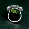A silver ring combined with a green crystal