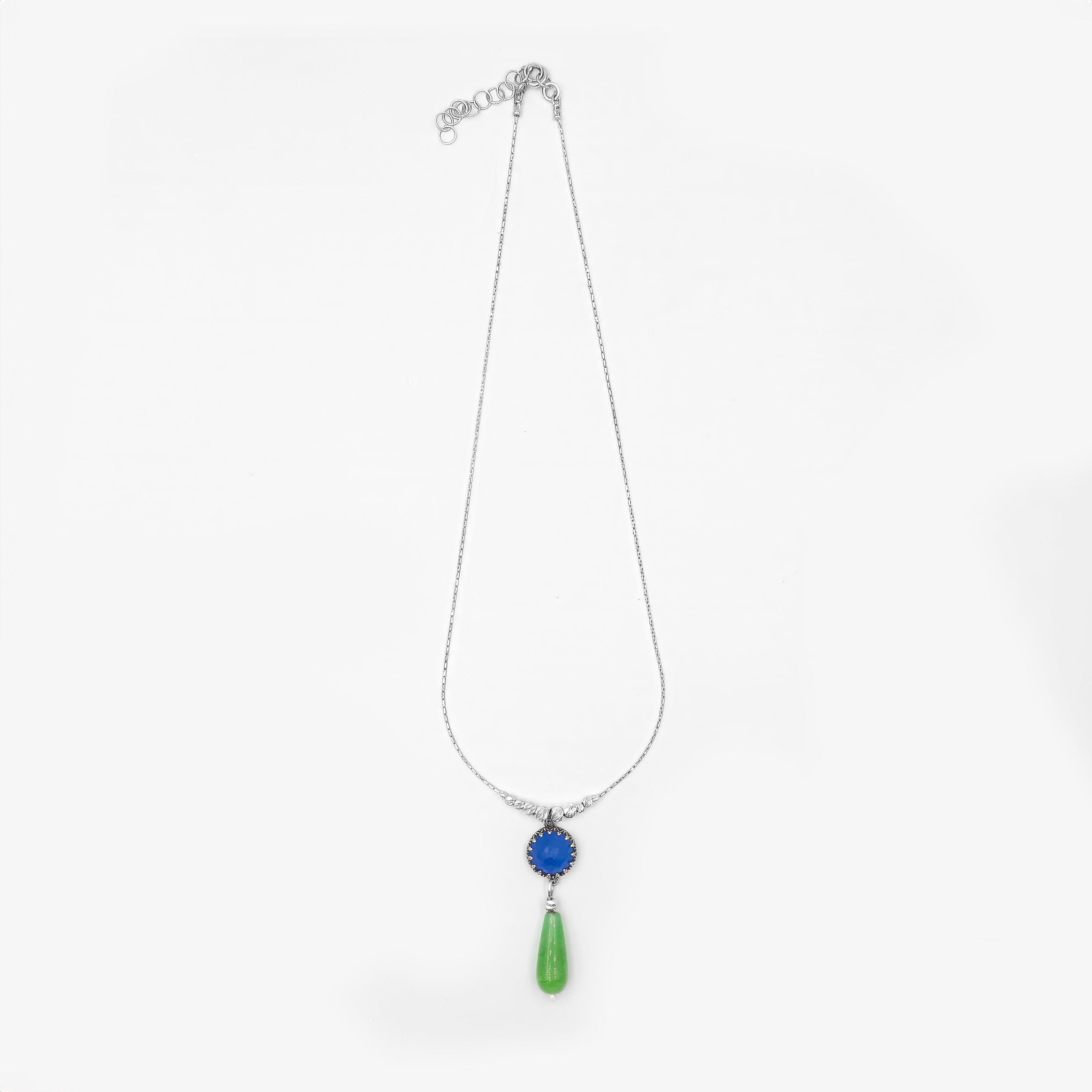 תליון דו-גוני ומרהיב על שרשרת כסף – אופלייט כחולה בהירה שמחזירה אור לצד אגת ירוקה עמוקה בגוון טבעי ומרגיע. מתנה מושלמת לאוהבות טבע, אסתטיקה רגועה ותכשיטים בעלי אנרגיה חיובית ועדינה.