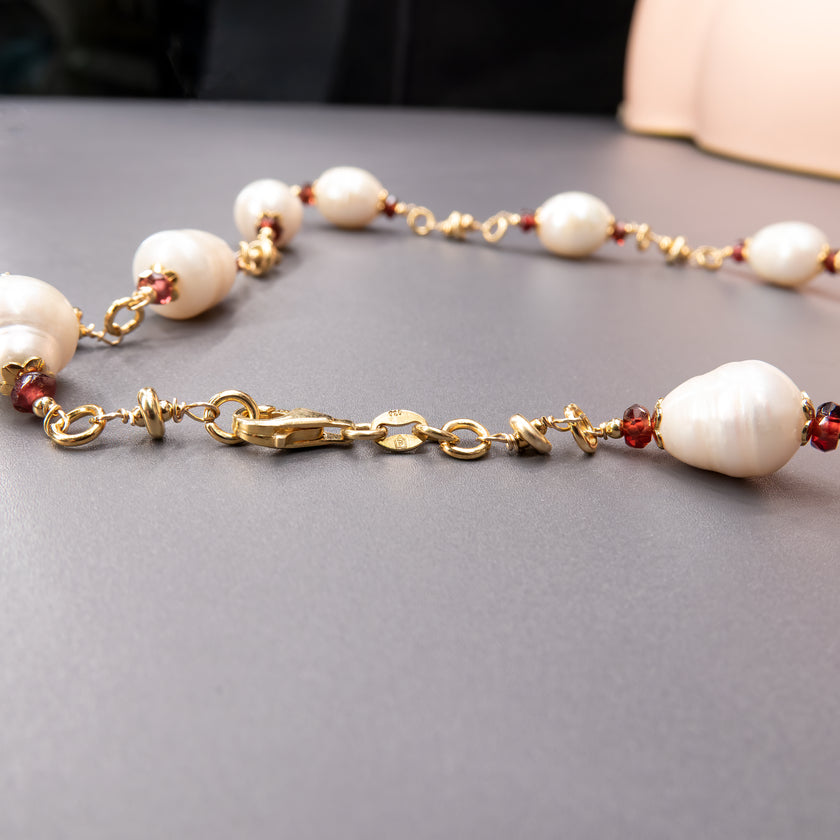 שרשרת אלגנטית המשלבת פנינים לבנות טבעיות עם גארנטים בגוון יין עמוק – ניגוד מרתק בין קלילות לעומק. הפנינים מעניקות לשרשרת זוהר פנימי בגוון לבן טהור, בעוד שהגארנטים מוסיפים עומק צבע ועומק גווני אדום כהה עם נגיעה דרמטית. התוצאה היא מראה עשיר, מאוזן והרמוני, שמתאים לנשים שאוהבות אלגנטיות עם אופי. השרשרת יכולה להשתלב במראה ערב יוקרתי או לשדרג הופעה יומיומית בנגיעה של צבע ואצילות. בחירה מושלמת למי שמחפשת שרשרת שמחברת רגש, צבע וסגנון.