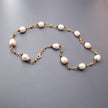 White pearl necklace and natural garnets