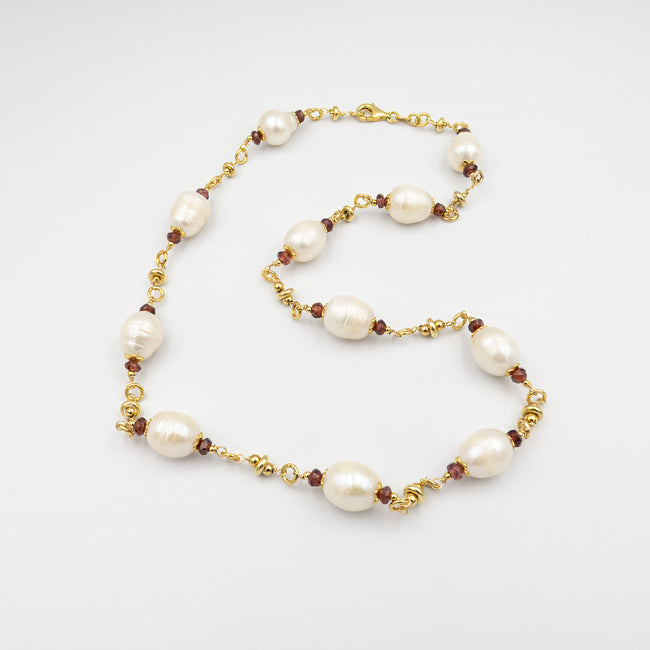 White pearl necklace and natural garnets