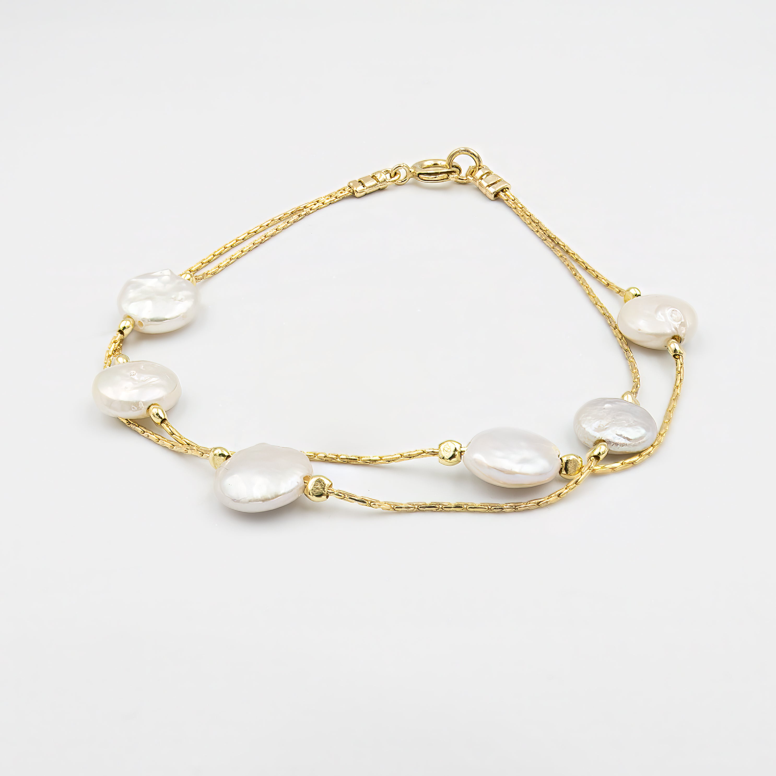 Elegant and minimalist, this dainty cultured pearl bracelet is a perfect choice for bridesmaids or the bride herself. The silver bracelet features stunning cultured pearls, adding a touch of timeless beauty to any wedding outfit. A beautiful bridesmaid gift, it also complements the bride’s look with understated charm and grace. This bracelet is a lovely addition to any wedding jewelry set, offering a delicate, sophisticated touch.