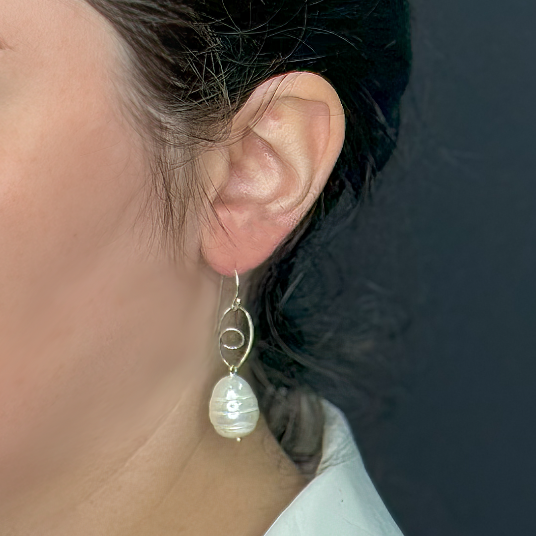 Silver earrings with a pearl in the shape of a drop