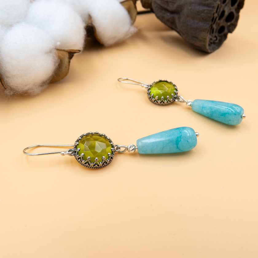 Handmade silver earrings with faceted lime-green round stones and dangling turquoise teardrops. The color combination evokes tropical energy and sunny elegance, ideal for beach weddings, vacation outfits, or bold everyday style. Feminine, fun, and full of personality, they make a great gift for artistic and vibrant women.

