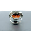 A silver ring combined with a crystal in the shade of garnet