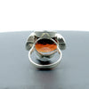 A silver ring combined with a crystal in the shade of garnet