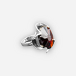 A silver ring combined with a crystal in the shade of garnet