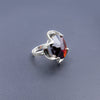 A silver ring combined with a crystal in the shade of garnet