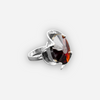 A silver ring combined with a crystal in the shade of garnet
