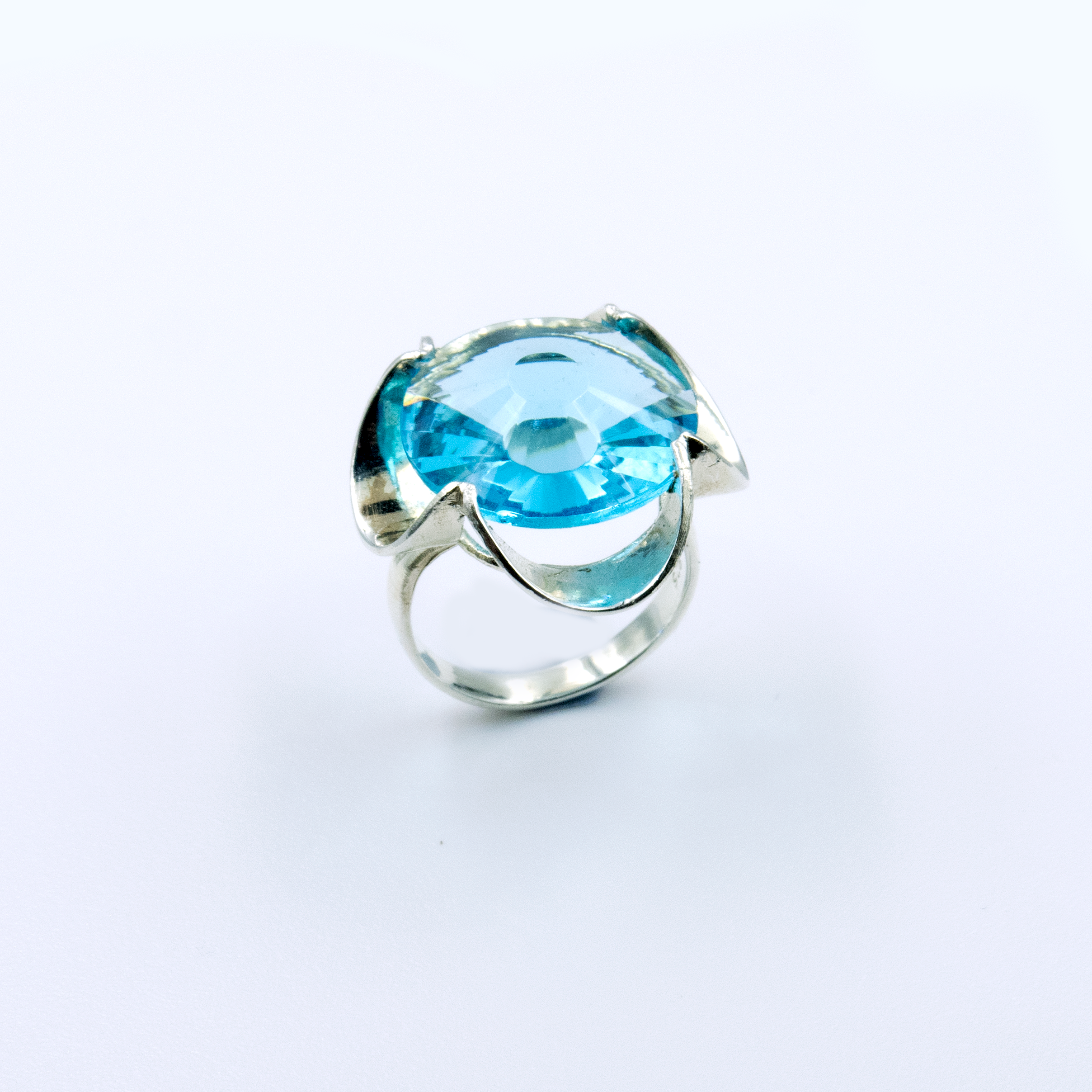 A silver ring combined with a crystal in a shade of aquamarine