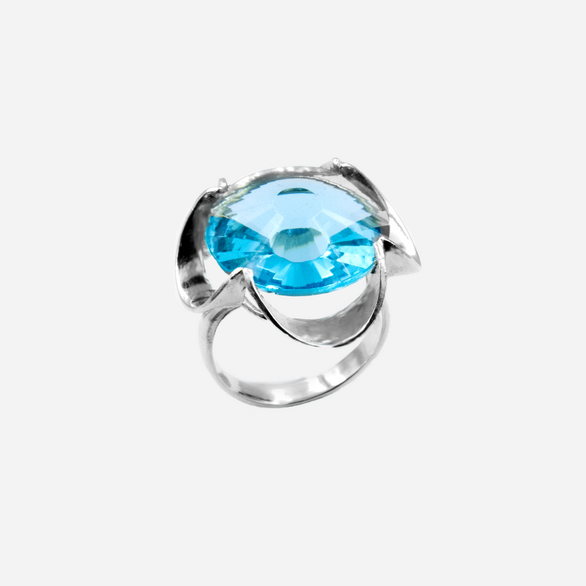 A silver ring combined with a crystal in a shade of aquamarine