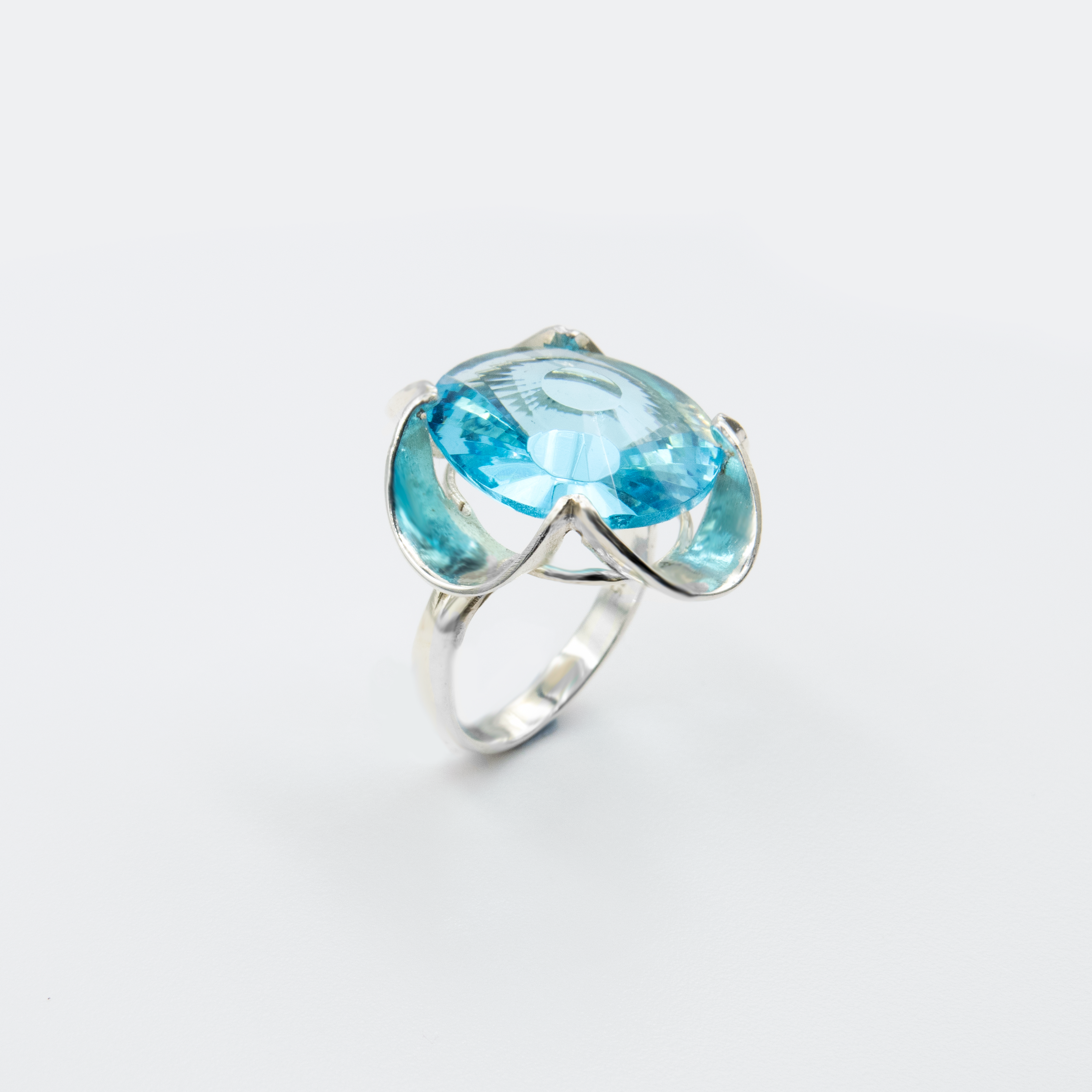 A silver ring combined with a crystal in a shade of aquamarine