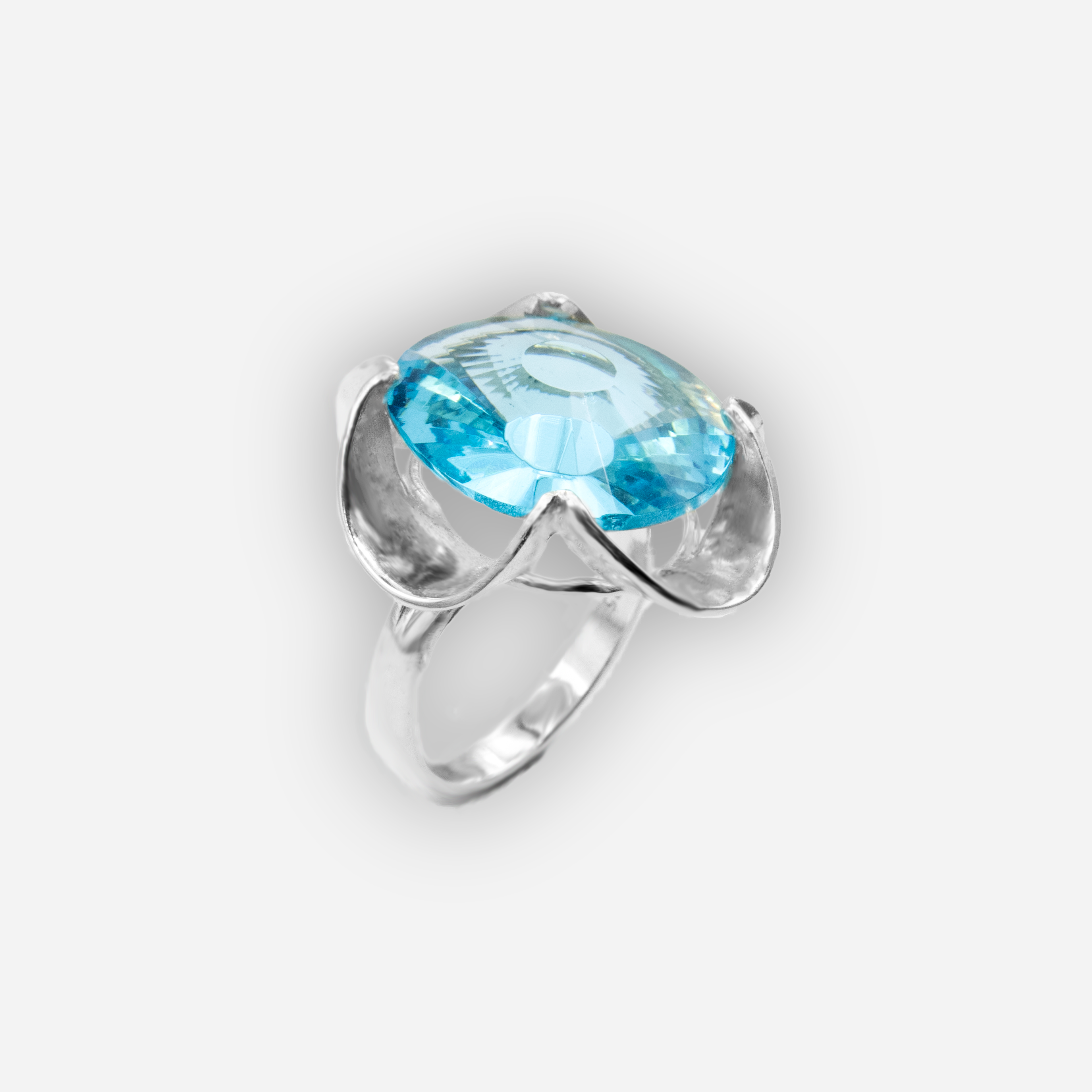 A silver ring combined with a crystal in a shade of aquamarine