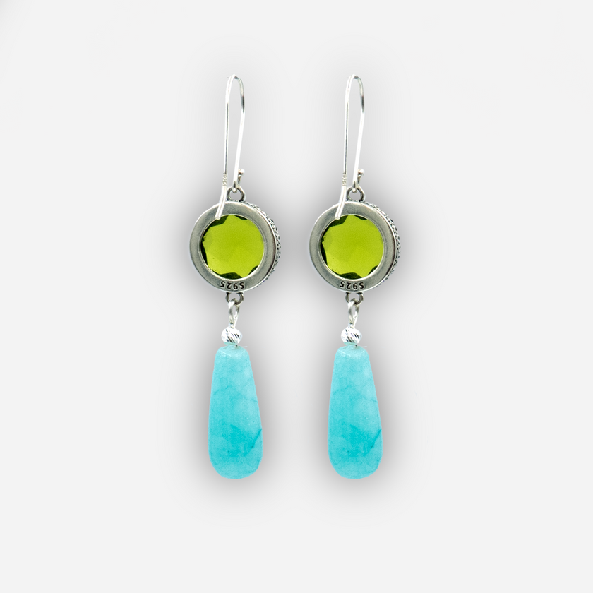 Playful and refined, these handcrafted earrings feature a brilliant green round stone set in an antique-style silver bezel, with a smooth turquoise teardrop suspended below. The contrast of textures and colors creates a lively accessory perfect for summer looks, boho chic styling, or casual evening wear. Unique and lightweight.

