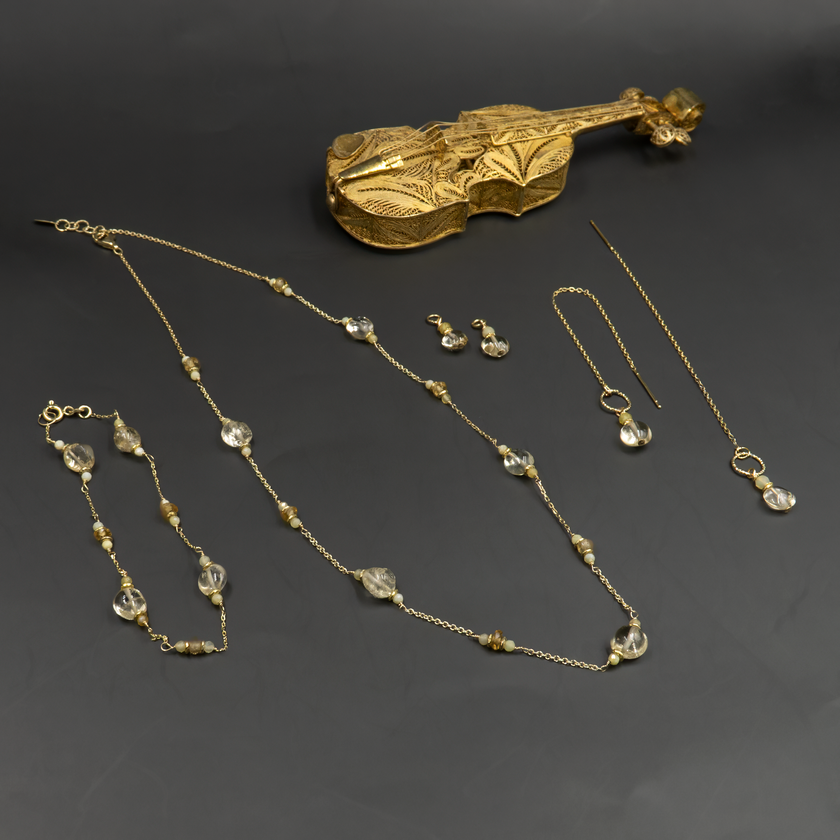 צמיד זהב 14 קראט עם טופז ואופל צהוב