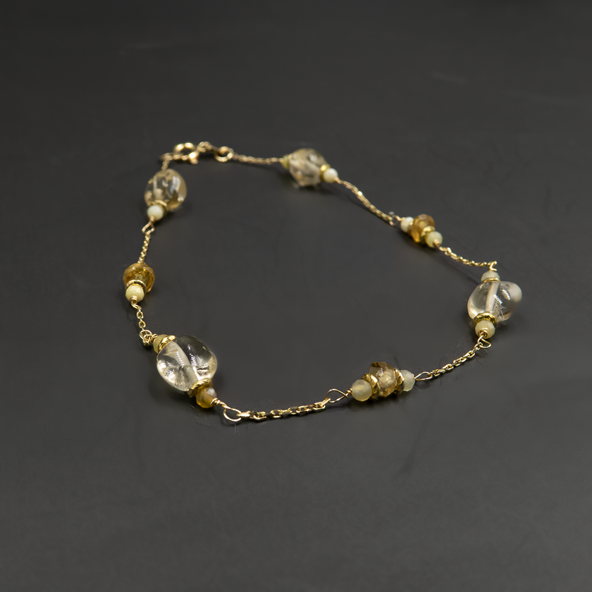 צמיד זהב 14 קראט עם טופז ואופל צהוב