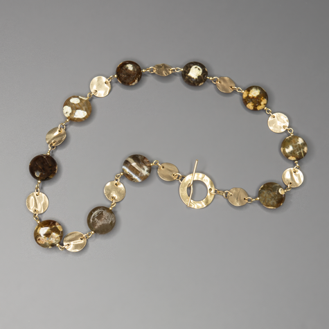 שרשרת אבן פיקאסו בעיבוד ייחודי בעבודת יד, עם מתכת גולדפילד זהובה ונגיעות של עיצוב בוהו־שיק טבעי. האבנים בגווני טבע חמים, יוצרות מראה הרמוני, עשיר ומעורר סקרנות – כל אבן נראית כמו ציור מינרלי ייחודי. השרשרת משלבת בין צבעים חמים, מרקמים חיים וזוהר עדין של זהב, ומעניקה תחושת עומק, קרקע ונשימה איטית. מתאימה לנשים עם סגנון אישי מובהק, שמחפשות תכשיט ייחודי, מעודן אך נוכח, שמשדר אהבה לחומרים אמיתיים. פריט מושלם ליום־יום עם טאץ' אחר, או כתוספת שקטה אך אלגנטית למראה ערב פשוט ונעים.