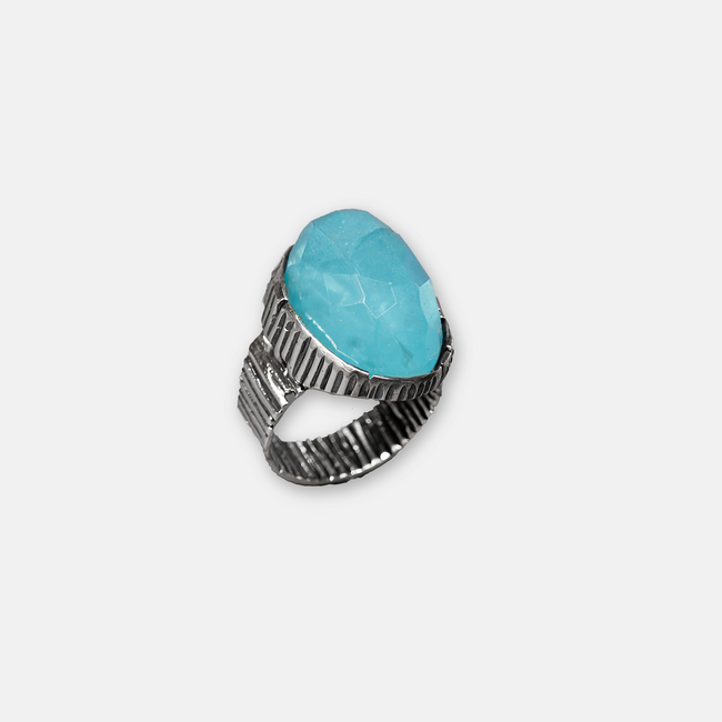 An oval silver ring with an ocean-hued opalite