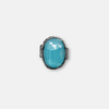 An oval silver ring with an ocean-hued opalite