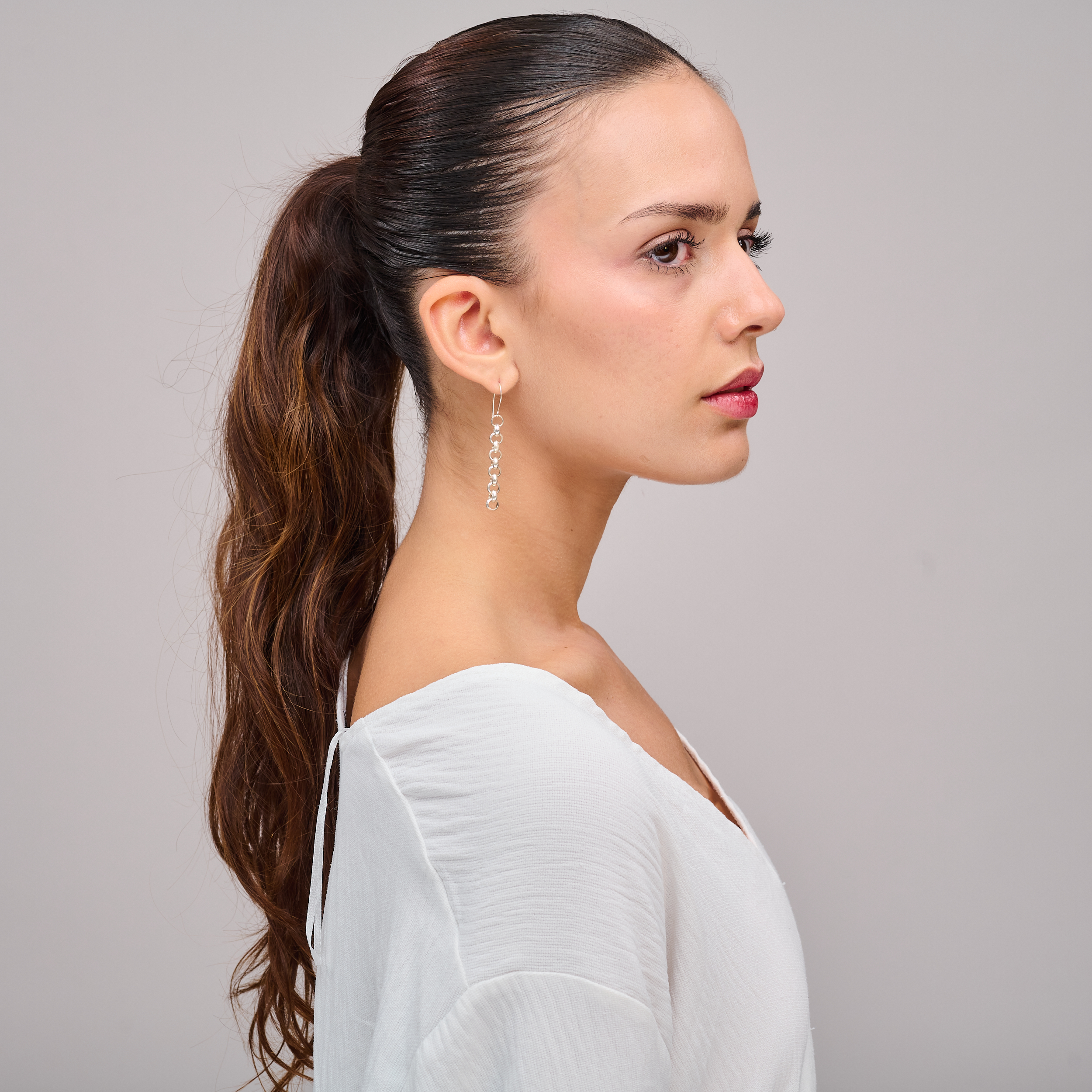 עגילים ארוכים מכסף ללא אבנים, בעיצוב שמשלב תנועה, קלילות וזוהר מתכתי. הבחירה המושלמת למי שאוהבת תכשיטים לא שגרתיים אך אלגנטיים. משלימים את הפנים באורך המחמיא ומוסיפים נגיעה עיצובית מיוחדת לכל הופעה.

