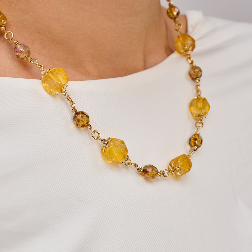 שרשרת בעבודת יד בגווני צהוב עזים ומלאי חיים – תכשיט שעושה מצב רוח טוב ברגע אחד. משחק בין חרוזים קטנים לגדולים, עם גימור מבריק וחי, יוצר תנועה מעניינת סביב הצוואר. מתנה נהדרת לנשים שאוהבות תכשיטים עם נוכחות ושמחת חיים.

