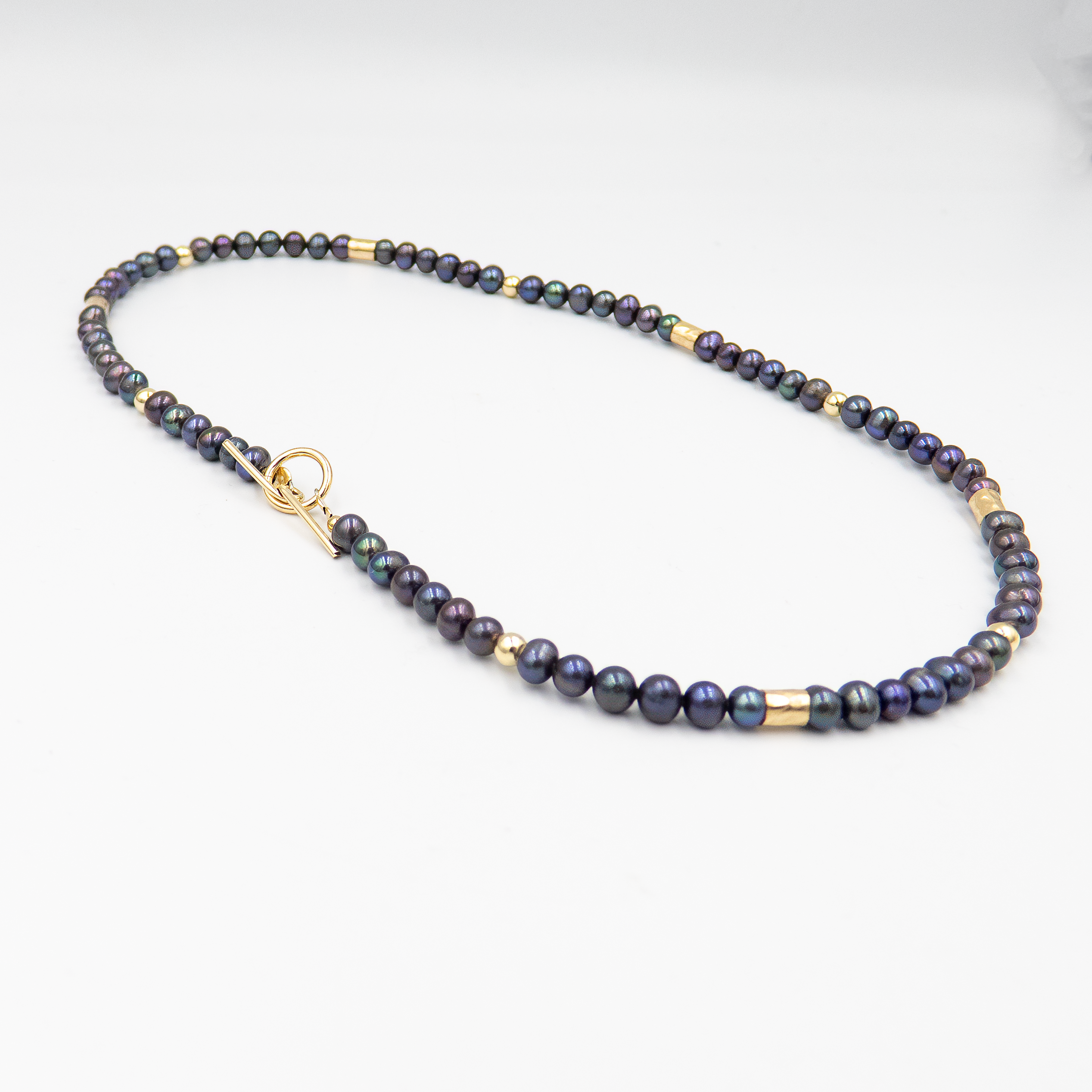 קולר אלגנטי עם פניני שחור וגולדפילד – קולר עם אמירה מסוגננת, שמשלב בין עומק אלגנטי לנגיעה חמימה של זהב. הפנינים השחורות יוצרות נוכחות דרמטית אך הרמונית, ואילו חרוזי הגולדפילד מוסיפים קונטרסט זוהר ושיק עכשווי. העיצוב הצמוד לצוואר מדגיש את קווי המתאר ומעניק מראה נשי, חזק ומתוחכם. תכשיט פריט ורסטילי שמשדר יוקרה ורוך.